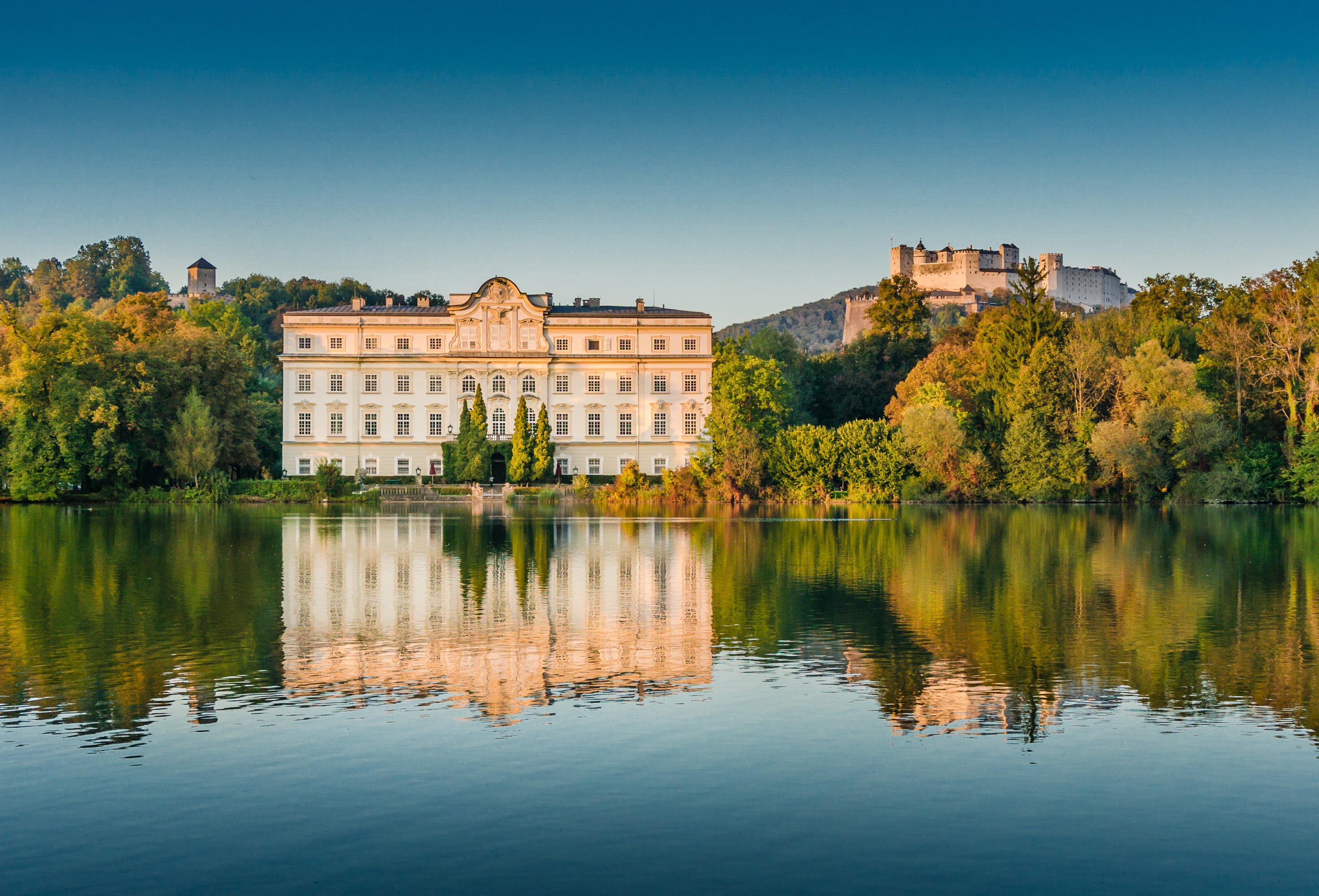 Schloss Leopoldskron am See, dahinter Festung Hohensalzburg, Drehort von Sound of Music in Salzburg